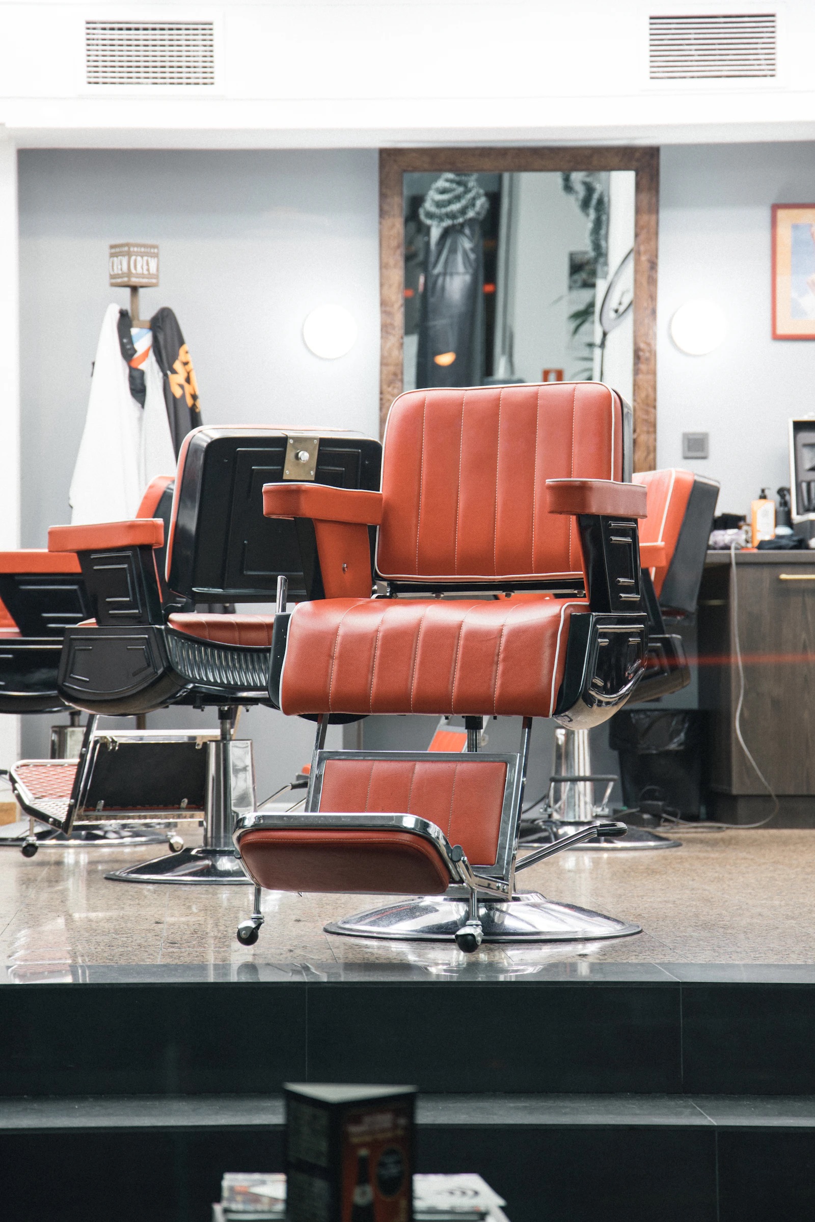 Leather barber chair in a dim, warm shop